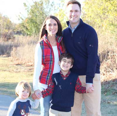 Drew Ihrig posing with his family in a fall landscape